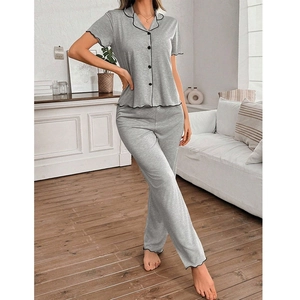 Detail of grey button-up pajama set with black lettuce edge trim and soft fabric texture
