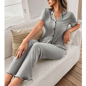 Detail of grey pajama set showing contrast piping on collar and lettuce trim hems