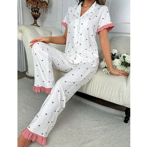 Women's pajama set featuring pink heart prints, short sleeve top, and long pants