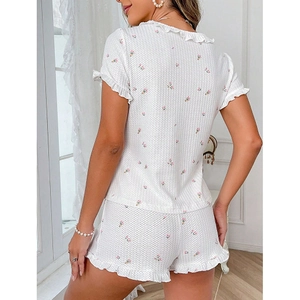 Detail of floral waffle knit loungewear set with ruffled edges and tie-up sleeve bows