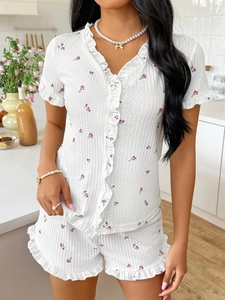 Close-up detail of floral waffle knit pajamas with ruffled trims and soft V-neckline
