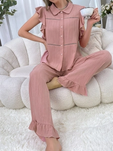Detail view of pink crinkle fabric pajama set with ruffle sleeves and lapel collar