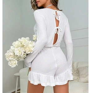 White waffle textured backless romper with long sleeves and elegant bow tie details
