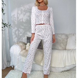 Detail of floral pajamas with delicate lace neckline and elastic ruffled cuffs
