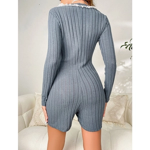 Back view of a grey-blue ribbed knit romper with white lace trim and long sleeves
