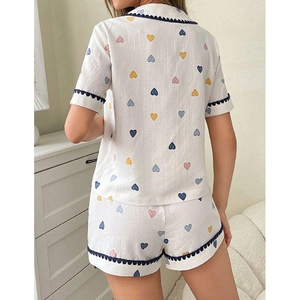 Women's pajama set featuring heart print short sleeve top and shorts in cream white