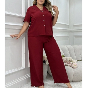Women's plus size burgundy pajama set with short sleeve button-up top and ruffle hem pants