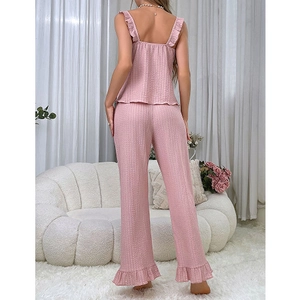 Pink sleeveless pajama set for women with ruffle trim and textured fabric on model