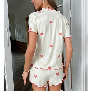 Women's heart print pajama set featuring ribbed fabric with pink wavy ruffled trim