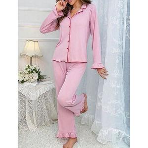 Pink long sleeve pajama set with ruffled edges and button-down collar for women
