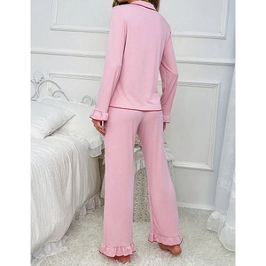 Pink women's pajama set with ruffled edges and contrasting red trim for casual home wear