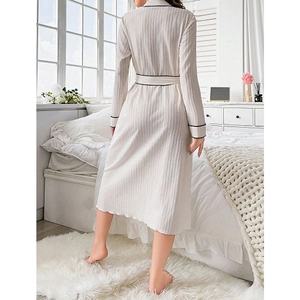 Elegant long-sleeved cream bathrobe for women with black trim and a waist belt design