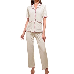 Women's 2-piece beige pajama set with short sleeve shirt, trousers and pink wavy trim