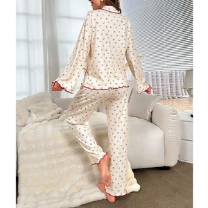 Women's pajama set featuring cherry print loungewear with elegant red scalloped edges