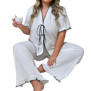 Women's white short sleeve pajamas set with black ribbon bows and ruffle trim detail