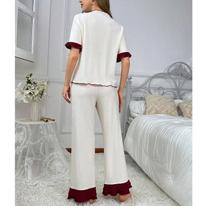 Women's waffle cotton pajama set featuring short sleeve top and pants with red ruffle trim
