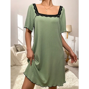 Pale green square neck ribbed nightdress with black lace trim in a cozy home setting