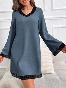 Detail of grey-blue knit nightdress featuring elegant black lace trim on V-neck and cuffs