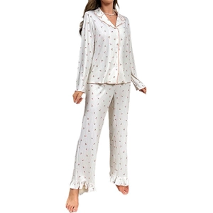 Women's floral pajama set featuring long sleeves with ruffle cuffs and pink edge piping
