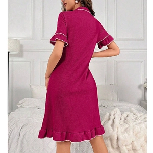 Deep pink short sleeve nightgown with lapel collar and ruffle hem in cozy home setting