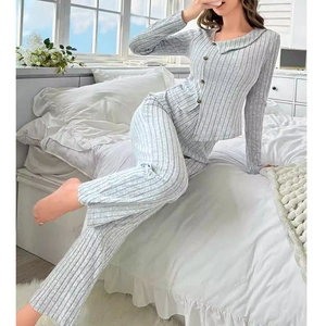 Detailed view of women's grey striped pajama set with wood-style buttons and ribbed knit texture