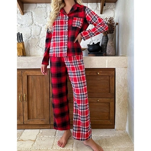 Detail of red and black plaid pajama set with classic button-down collar and soft fabric