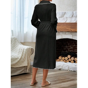 Back view of black long sleeve lounge robe with white contrast trim and waist tie belt