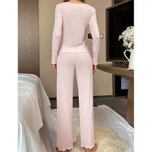 Pink ribbed long sleeve pajama set for women with ruffle hem and back view detail