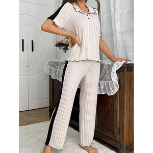 Women's 2-piece cream loungewear set with contrast black trim and striped knit texture