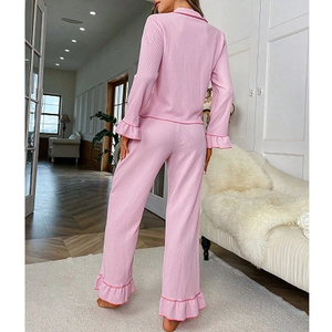 Detail view of pink pajama set featuring ruffle hems and contrast piping on sleeves
