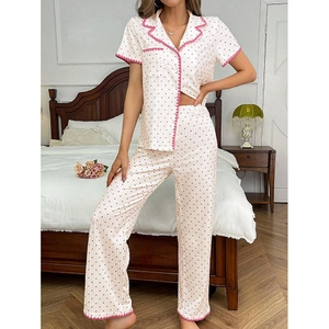 Detail of short sleeve heart print pajama set featuring scalloped pink trim edges