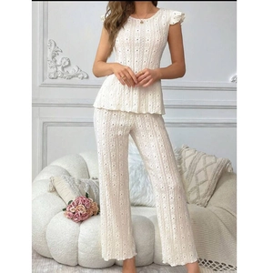 Detail of the elegant white hollow knit fabric texture on the two-piece loungewear set