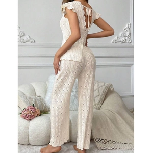 Detail of crochet texture on backless cream loungewear set with ruffle sleeve accents