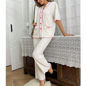 Detail of V-neck button-down pajama set with pink piping and pleated texture fabric