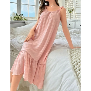 Detailed texture of pink sleeveless nightdress with ruffled straps and ribbed fabric