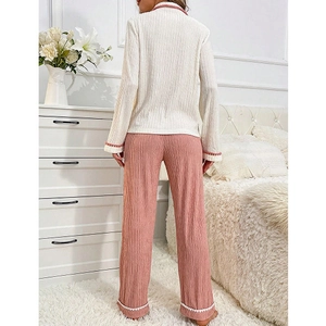 Chic two-piece women's pajama set featuring a cream lace top and pink ribbed long pants