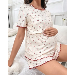 Detail of cherry print maternity pajamas with elegant red lettuce trim on ribbed fabric