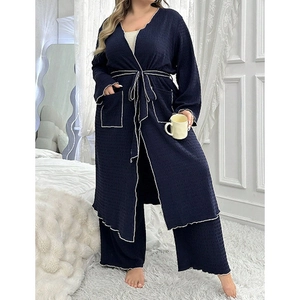 Detail of dark blue waffle textured robe set with contrast piping and belted waist