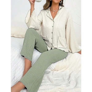 Close-up of waffle texture pajama set featuring green piping and contrast buttons