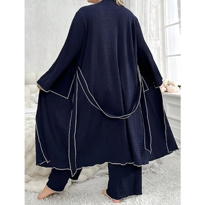Three-piece waffle knit loungewear set with dark blue robe and pants featuring white trim