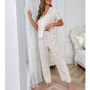 Short sleeve floral pajama set with lapel shirt and matching pants in a cozy indoor setting