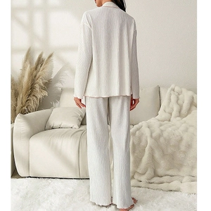 Women's ribbed knit pajama set featuring a button-down lapel top and long pants in cream