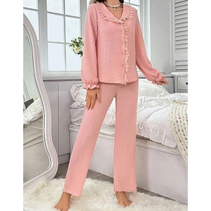 Pink waffle knit pajama set with ruffle trim collar and long pants for women
