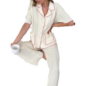 Women's two-piece cream pajama set with short-sleeve button top and plissé trousers