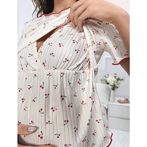 Detail of cherry print nursing pajama top with double-layer opening and red wavy edges