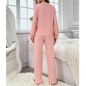 Rear view of pink long sleeve pajama set with waffle texture and ruffled collar details