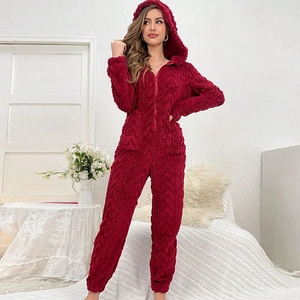 Detail view of burgundy fleece hooded onesie with textured cable knit pattern