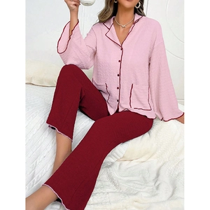 Detail of pink pajama top featuring contrast piping and ruffled cuffs with ribbed texture