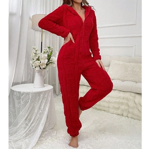 Detail of red fleece onesie featuring embossed teddy bear patterns and warm texture
