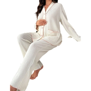 Women's pajama set with lapel button-down top and pants featuring pink piping trim